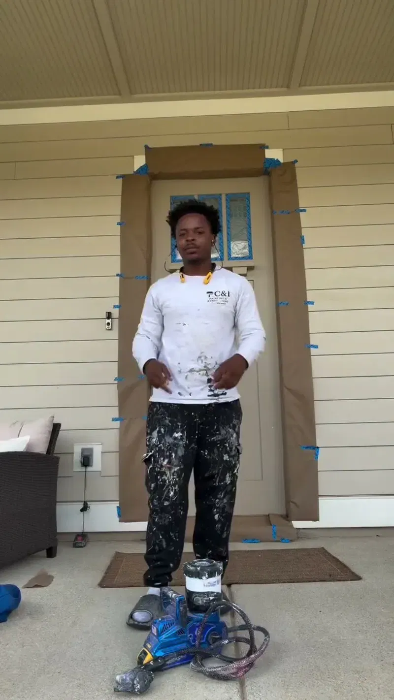 Painter carefully preparing a residential door before refinishing